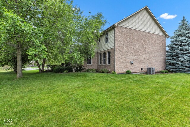 705 Ridge Gate Dr, Brownsburg, IN 46112 - view of side of home with brick siding and a yard