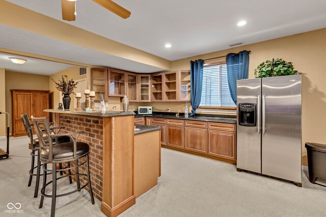 705 Ridge Gate Dr, Brownsburg, IN 46112 - kitchen featuring stainless steel refrigerator with ice dispenser, a breakfast bar, light colored carpet, glass insert cabinets, and recessed lighting