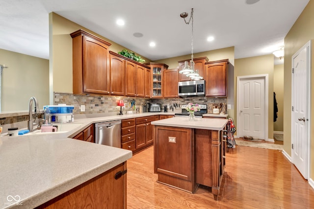 705 Ridge Gate Dr, Brownsburg, IN 46112 - kitchen featuring stainless steel appliances, tasteful backsplash, light countertops, glass insert cabinets, and recessed lighting