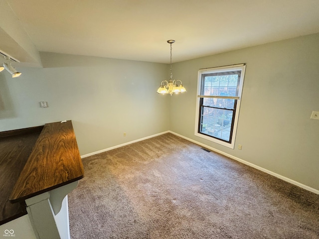 4408 Clovelly Ct, Indianapolis, IN 46254 - unfurnished dining area featuring dark colored carpet and a chandelier