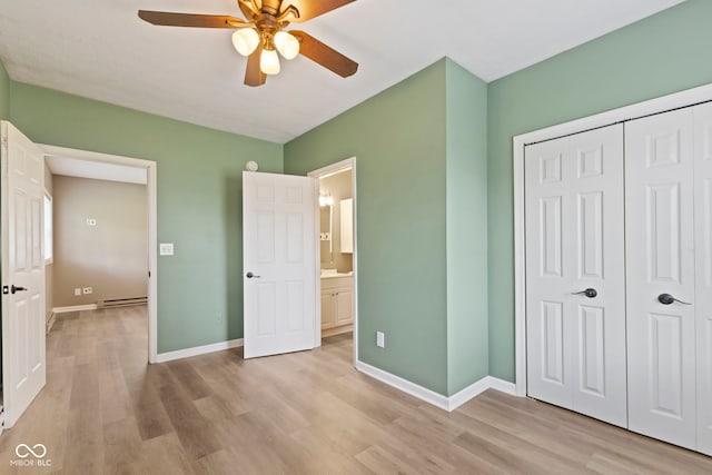 7928 Vontress St, Coatesville, IN 46121 - unfurnished bedroom featuring light wood-style floors, a closet, ceiling fan, and a baseboard heating unit