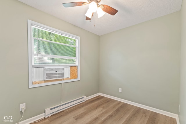 7928 Vontress St, Coatesville, IN 46121 - empty room featuring baseboard heating, wood finished floors, a ceiling fan, cooling unit, and a textured ceiling