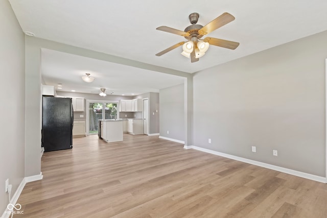 7928 Vontress St, Coatesville, IN 46121 - unfurnished living room featuring a ceiling fan and light wood finished floors