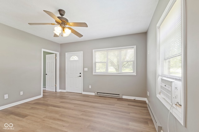 7928 Vontress St, Coatesville, IN 46121 - foyer with a baseboard heating unit, a baseboard radiator, a ceiling fan, and light wood-style flooring