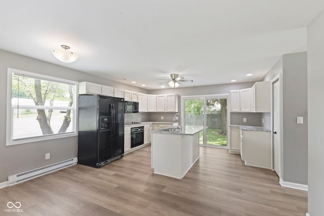 7928 Vontress St, Coatesville, IN 46121 - kitchen with black appliances, a baseboard radiator, white cabinetry, ceiling fan, and recessed lighting