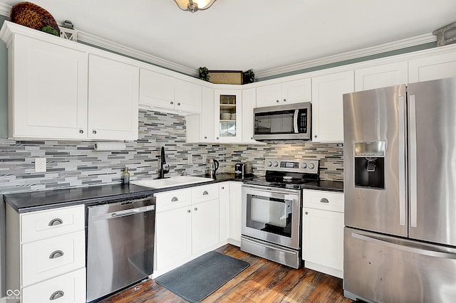 12606 Markay Dr, Fishers, IN 46038 - kitchen featuring stainless steel appliances, dark countertops, dark wood-style flooring, and white cabinetry