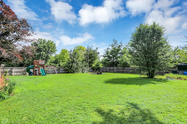 12606 Markay Dr, Fishers, IN 46038 - fenced backyard featuring a playground and view of wooded area