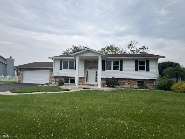 15 Morton Way, Batesville, IN 47006 - raised ranch featuring an attached garage, a front yard, asphalt driveway, and brick siding