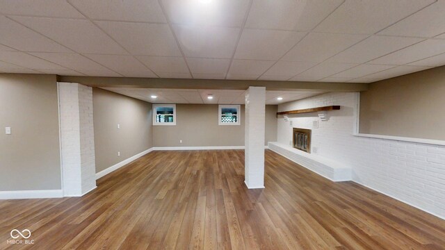15 Morton Way, Batesville, IN 47006 - basement with wood finished floors, a brick fireplace, brick wall, and a paneled ceiling