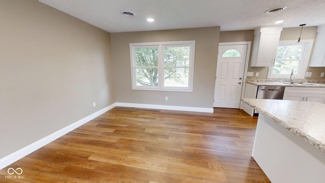 15 Morton Way, Batesville, IN 47006 - kitchen featuring white cabinets, healthy amount of natural light, light wood finished floors, hanging light fixtures, and recessed lighting