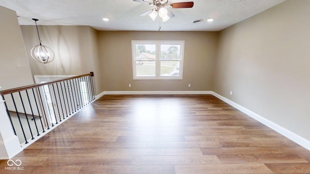 15 Morton Way, Batesville, IN 47006 - unfurnished room with ceiling fan, wood finished floors, a chandelier, and recessed lighting