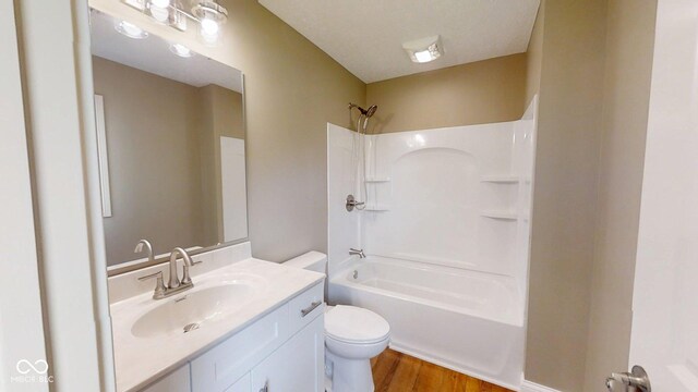 15 Morton Way, Batesville, IN 47006 - bathroom featuring vanity, wood finished floors, and washtub / shower combination