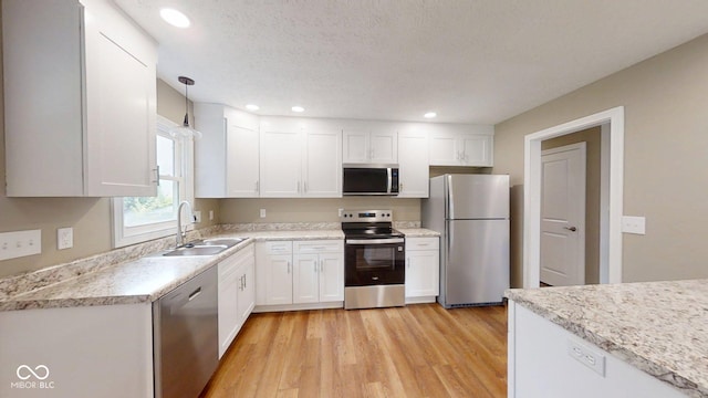 15 Morton Way, Batesville, IN 47006 - kitchen featuring appliances with stainless steel finishes, light wood-type flooring, white cabinetry, decorative light fixtures, and recessed lighting