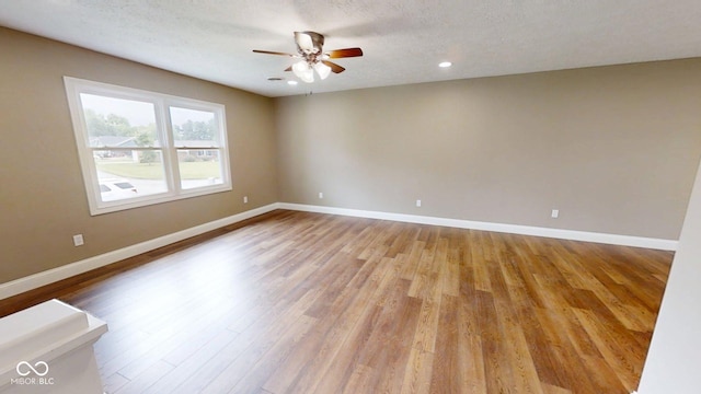 15 Morton Way, Batesville, IN 47006 - unfurnished room with wood finished floors, a ceiling fan, recessed lighting, and a textured ceiling