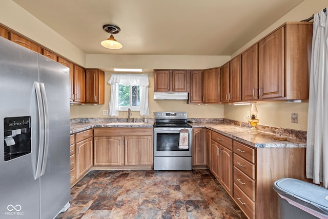 10965 W Base Line Rd, Jamestown, IN 46147 - kitchen featuring appliances with stainless steel finishes, under cabinet range hood, stone finish flooring, light countertops, and brown cabinetry