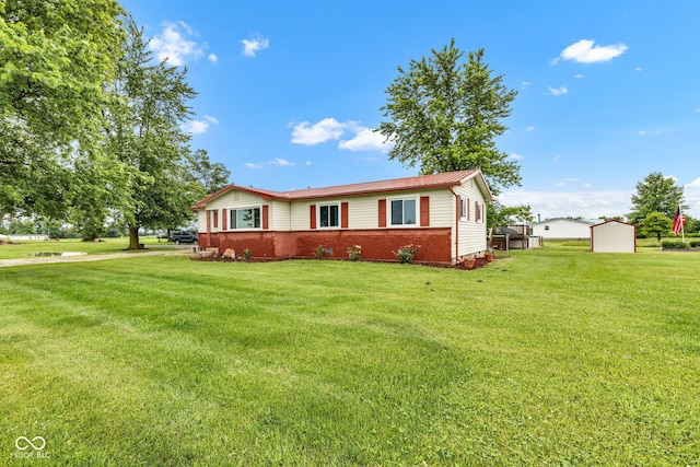 10965 W Base Line Rd, Jamestown, IN 46147 - view of front facade featuring a front yard, a storage unit, and brick siding