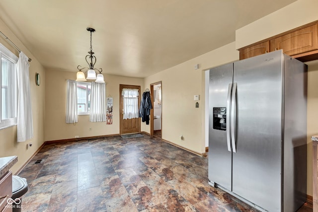 10965 W Base Line Rd, Jamestown, IN 46147 - kitchen with stainless steel fridge with ice dispenser, dark stone finish floors, decorative light fixtures, and brown cabinets