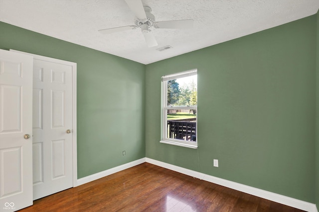 9055 Glass Chimney Ln, Fishers, IN 46037 - unfurnished bedroom with dark wood finished floors, a textured ceiling, and ceiling fan