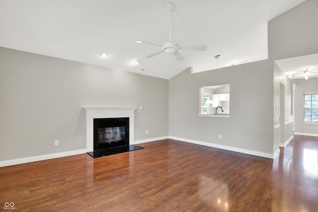 9055 Glass Chimney Ln, Fishers, IN 46037 - unfurnished living room with ceiling fan, hardwood / wood-style floors, a glass covered fireplace, and high vaulted ceiling