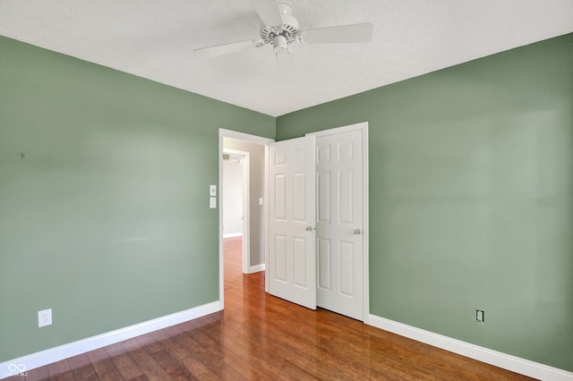 9055 Glass Chimney Ln, Fishers, IN 46037 - unfurnished bedroom with wood finished floors, a textured ceiling, a ceiling fan, and a closet