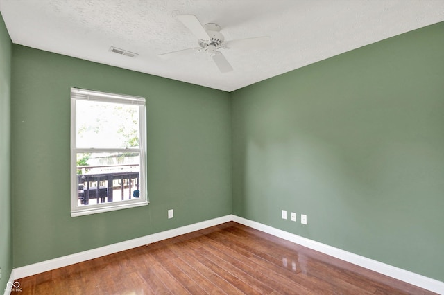 9055 Glass Chimney Ln, Fishers, IN 46037 - empty room with dark wood-type flooring, ceiling fan, and a textured ceiling