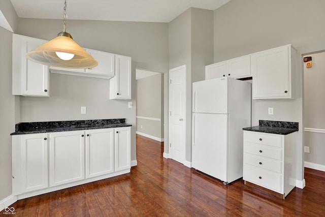 9055 Glass Chimney Ln, Fishers, IN 46037 - kitchen with freestanding refrigerator, white cabinets, dark wood finished floors, dark stone counters, and vaulted ceiling