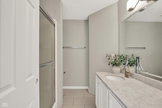 9055 Glass Chimney Ln, Fishers, IN 46037 - full bathroom featuring tile patterned flooring, vanity, an enclosed shower, and a textured ceiling