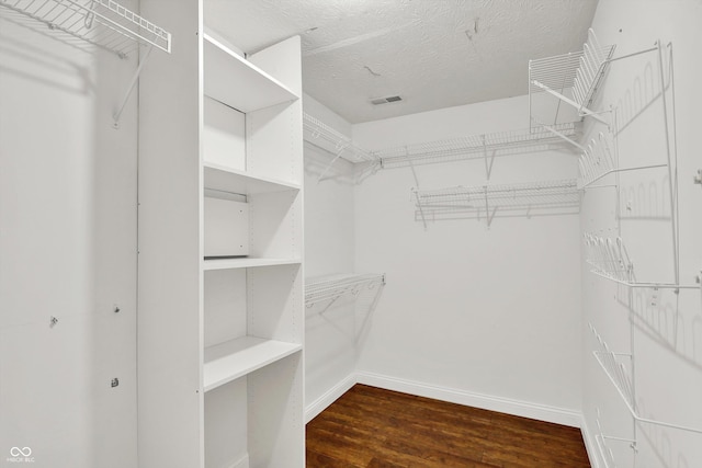 9055 Glass Chimney Ln, Fishers, IN 46037 - walk in closet with dark wood-type flooring