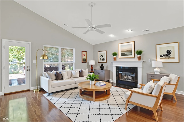 9055 Glass Chimney Ln, Fishers, IN 46037 - living room featuring ceiling fan, wood finished floors, high vaulted ceiling, plenty of natural light, and a fireplace with flush hearth