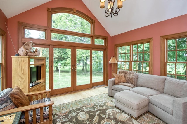 5538 N 700 W, Mccordsville, IN 46055 - living area featuring wood finished floors, a chandelier, plenty of natural light, high vaulted ceiling, and french doors