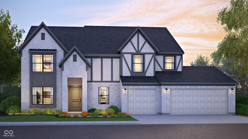 3638 Sycamore Bend Way N, Columbus, IN 47203 - view of front facade with driveway, roof with shingles, stucco siding, and brick siding