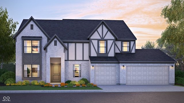 3638 Sycamore Bend Way N, Columbus, IN 47203 - view of front facade with driveway, roof with shingles, stucco siding, and brick siding