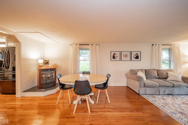 4491 W 600 N, Anderson, IN 46011 - dining room with a wood stove, light wood finished floors, and plenty of natural light