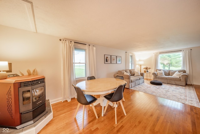 4491 W 600 N, Anderson, IN 46011 - dining room featuring light wood-style flooring and a wood stove