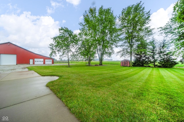 4491 W 600 N, Anderson, IN 46011 - view of green lawn with an outbuilding, a detached garage, and driveway