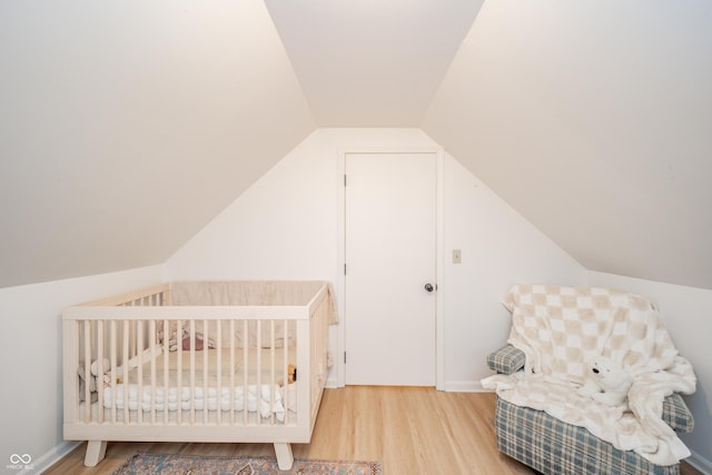 4491 W 600 N, Anderson, IN 46011 - bedroom with wood finished floors, vaulted ceiling, and a crib