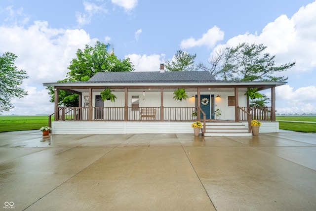 4491 W 600 N, Anderson, IN 46011 - view of front of property featuring a porch, roof with shingles, and a chimney