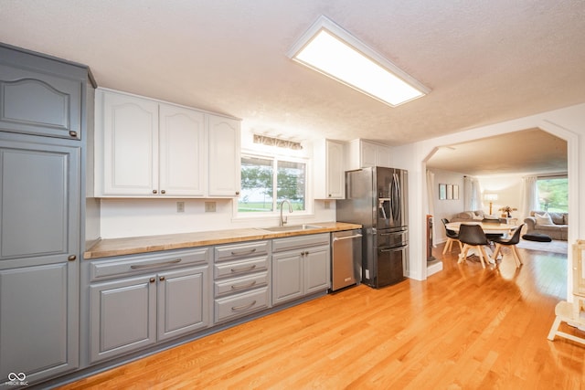 4491 W 600 N, Anderson, IN 46011 - kitchen featuring stainless steel dishwasher, refrigerator with ice dispenser, light wood-style flooring, and white cabinets