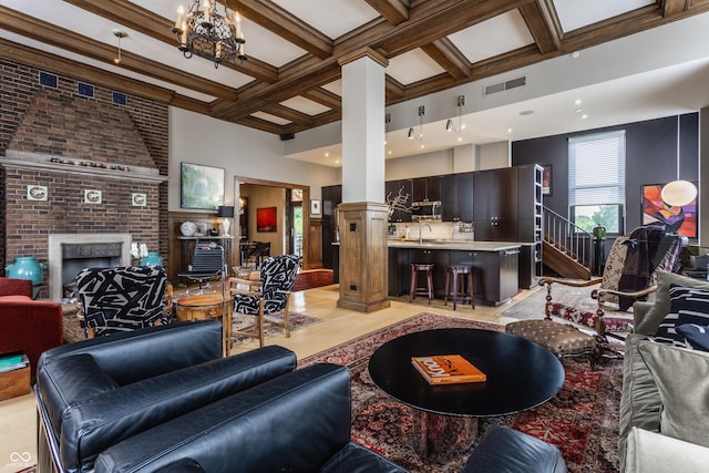 3959 Central Ave, Indianapolis, IN 46205 - living area with a high ceiling, a fireplace, beam ceiling, coffered ceiling, and light wood-style flooring