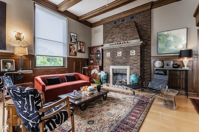 3959 Central Ave, Indianapolis, IN 46205 - living room with wood finished floors, a wainscoted wall, beam ceiling, and a fireplace