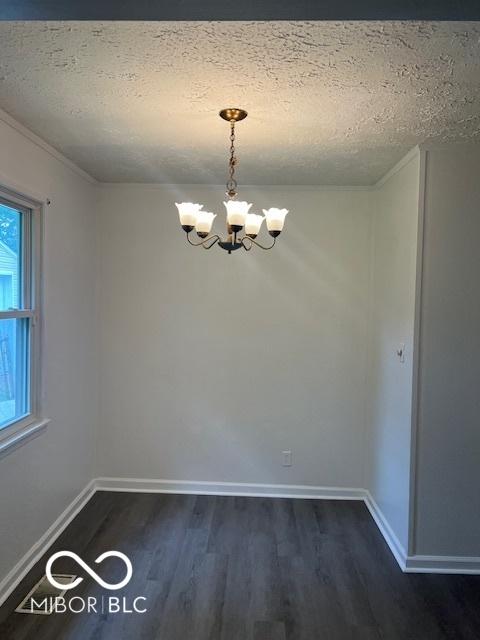 5312 N Kercheval Dr, Indianapolis, IN 46226 - unfurnished room featuring a chandelier, a textured ceiling, dark wood finished floors, and crown molding