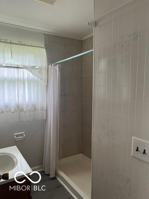 5312 N Kercheval Dr, Indianapolis, IN 46226 - bathroom with a tile shower and vanity