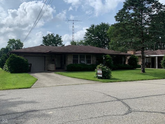 24 David Dr, North Vernon, IN 47265 - ranch-style home featuring concrete driveway, a garage, and a front lawn