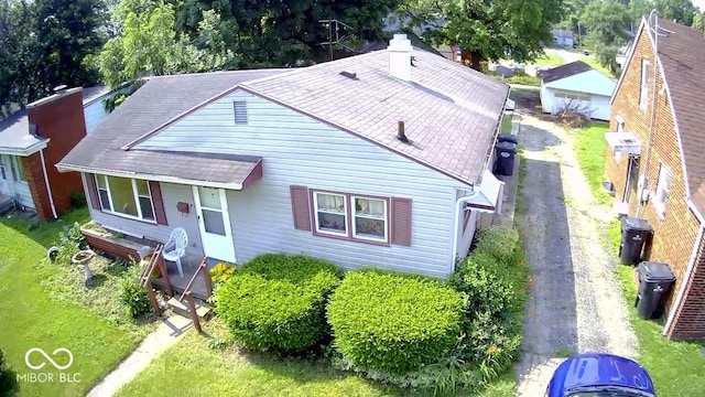 1227 W 9th St, Anderson, IN 46016 - view of front facade with a chimney and roof with shingles