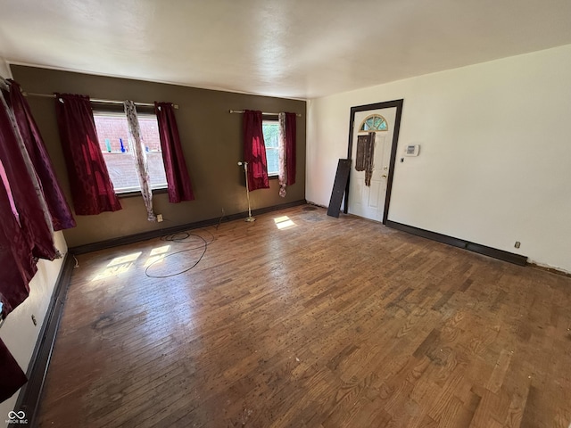 1227 W 9th St, Anderson, IN 46016 - unfurnished living room with wood finished floors and baseboards