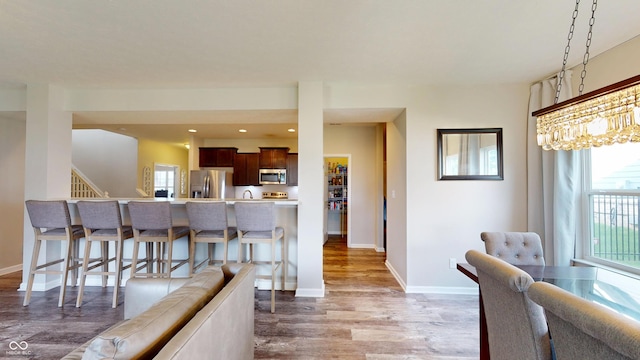 16551 Branham Dr, Fishers, IN 46040 - dining area featuring wood finished floors, stairs, and recessed lighting