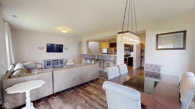 16551 Branham Dr, Fishers, IN 46040 - living room featuring wood finished floors, stairs, and a chandelier