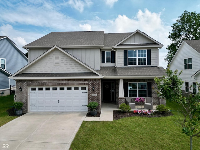 16551 Branham Dr, Fishers, IN 46040 - craftsman-style house with covered porch, concrete driveway, a front yard, brick siding, and board and batten siding