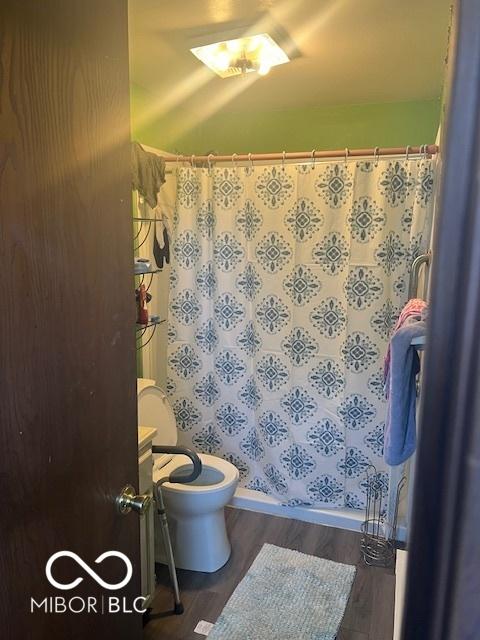 2021 Columbia Ave, Indianapolis, IN 46202 - full bathroom featuring wood finished floors, vanity, and a shower with curtain