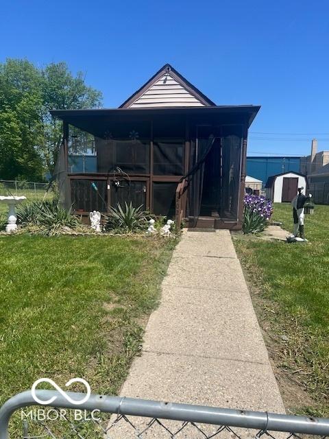 2021 Columbia Ave, Indianapolis, IN 46202 - view of front facade featuring a front yard and a shed